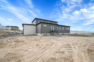 Rear view of property with a mountain view