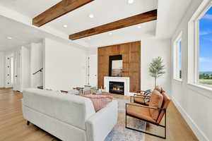 Living room featuring beam ceiling and light hardwood / wood-style floors