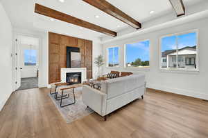 Living room featuring beam ceiling and light hardwood / wood-style floors