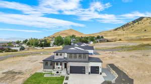 View of front of home featuring a mountain view and a garage