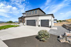 View of front of house featuring a garage and a mountain view