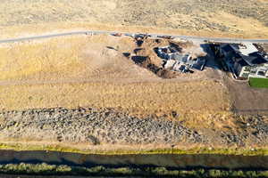 Birds eye view of property with a water view