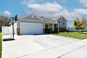 View of front facade featuring a front yard and a garage