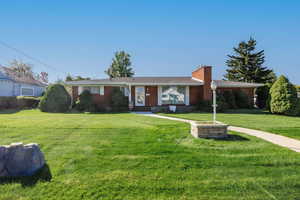 Ranch-style house featuring a front lawn