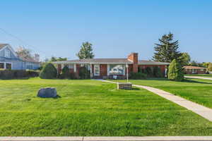 Single story home with a front lawn