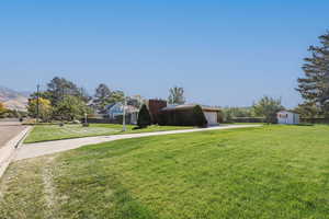 View of yard with a storage unit and a garage