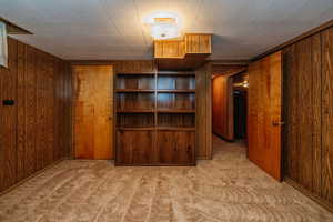 Interior space with wooden walls and light colored carpet