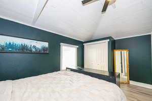 Bedroom featuring vaulted ceiling, a closet, ceiling fan, and light hardwood / wood-style flooring