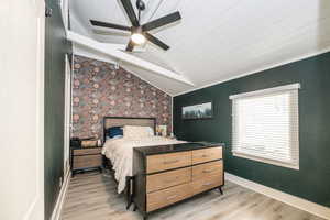 Bedroom featuring vaulted ceiling with beams, wood ceiling, ceiling fan, and light hardwood / wood-style flooring