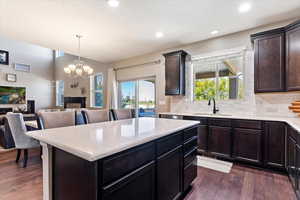 Kitchen featuring a wealth of natural light, dark wood-type flooring, and sink