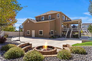 Back of property featuring a patio and an outdoor fire pit