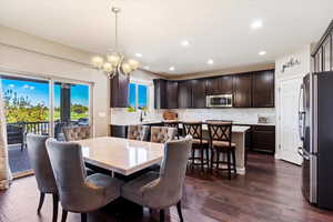 Dining room featuring a chandelier, a textured ceiling, sink, and dark hardwood / wood-style flooring