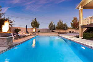 Pool at dusk with a patio area