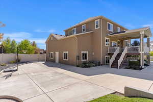 Rear view of house featuring a patio and ceiling fan