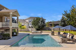 View of pool featuring ceiling fan and a patio