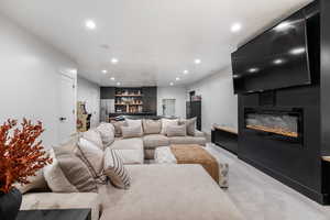 Carpeted living room with a large fireplace