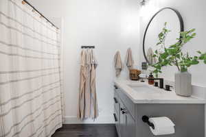 Bathroom featuring vanity, hardwood / wood-style floors, and a shower with shower curtain