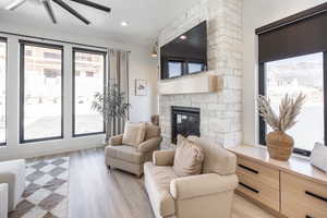 Living room with light hardwood / wood-style flooring, a textured ceiling, and plenty of natural light