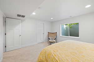 Bedroom with light carpet
