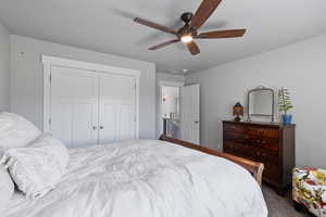 Bedroom with a closet, carpet, and ceiling fan
