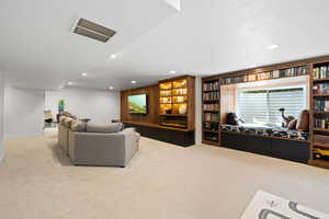 Carpeted living room featuring a textured ceiling