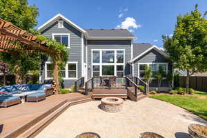 Back of house with a patio, an outdoor living space with a fire pit, and a wooden deck