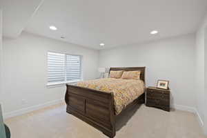 Bedroom featuring light carpet