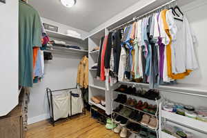 Spacious closet featuring light hardwood / wood-style floors