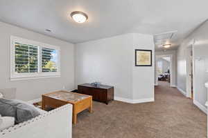 Carpeted living room featuring a textured ceiling