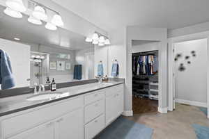 Bathroom featuring a textured ceiling, vanity, and hardwood / wood-style flooring