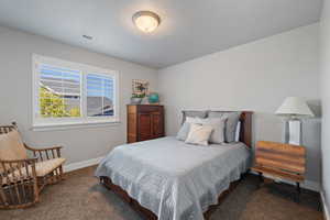 Carpeted bedroom with a textured ceiling