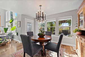 Dining room featuring a textured ceiling, light hardwood / wood-style floors, and a wealth of natural light