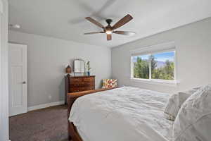 Bedroom featuring a textured ceiling, carpet, and ceiling fan