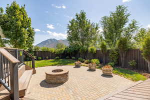 View of patio with an outdoor fire pit and a mountain view