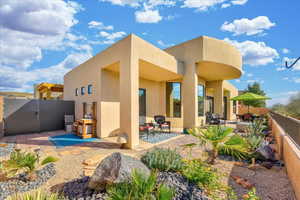 Back of house with a patio area