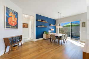 Dining space with hardwood / wood-style floors