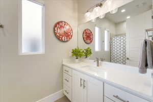 Bathroom with vanity and a shower with shower curtain