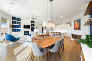 Dining area with ceiling fan and light wood-type flooring