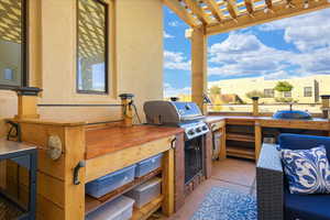 View of patio / terrace featuring a pergola, area for grilling, and exterior kitchen