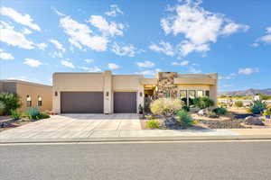 Pueblo-style house featuring a mountain view and a garage