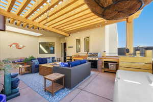 View of patio featuring area for grilling, an outdoor hangout area, and a pergola