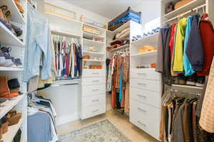 Walk in closet featuring light tile patterned flooring