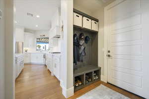 Mudroom with light hardwood / wood-style floors