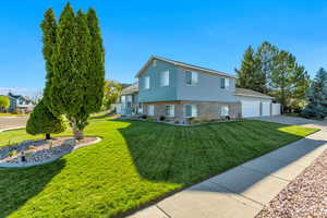 View of side of property with a yard