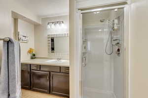 Bathroom featuring walk in shower and vanity