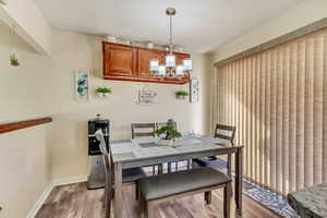 Dining space featuring an inviting chandelier and light hardwood / wood-style flooring