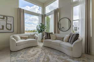 Elevated from the street, the serene living room floats above the bustle and features the expansive sky and mountains. What a welcome reception after a long day!