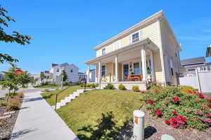 View of front of home featuring a front yard and a porch