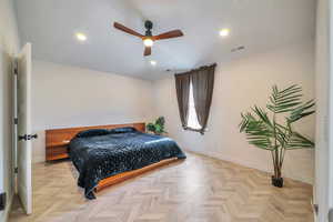 Bedroom featuring ceiling fan and light parquet floors