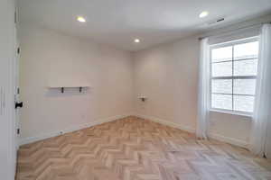 Spare room featuring light parquet flooring